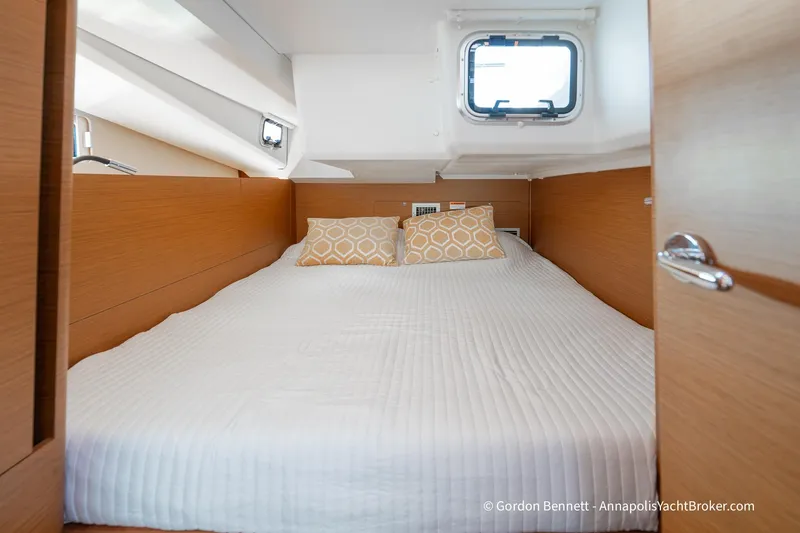 Slide: The Image of Cozy cabin interior of 2022 Jeanneau Sun Odyssey 440 yacht with bed and window. - 11