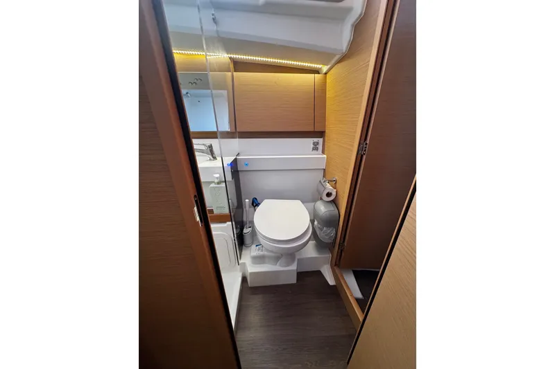 Slide: The Image of Modern bathroom in 2022 Jeanneau Sun Odyssey 440 yacht, featuring sleek design and wood accents. - 14