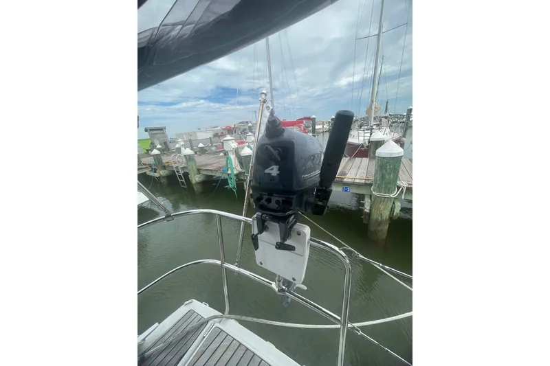 Slide: The Image of Outboard motor on Jeanneau Sun Odyssey 440 sailboat, docked at marina, 2022 model. - 30