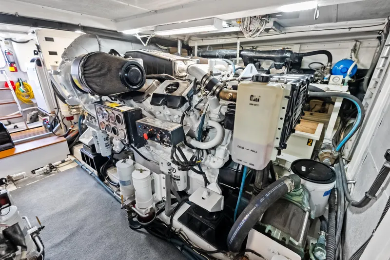 Slide: The Image of Engine room of 2005 Grand Banks 72 Aleutian RP yacht, featuring complex machinery and controls. - 148