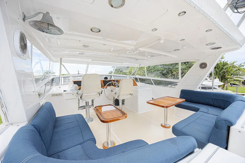 Slide: The Image of Luxurious 2005 Grand Banks 72 Aleutian RP yacht interior with blue seating and wooden tables. - 23