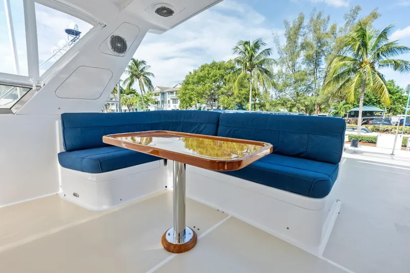 Slide: The Image of Luxurious 2005 Grand Banks 72 Aleutian RP yacht with blue seating and wooden table. - 137