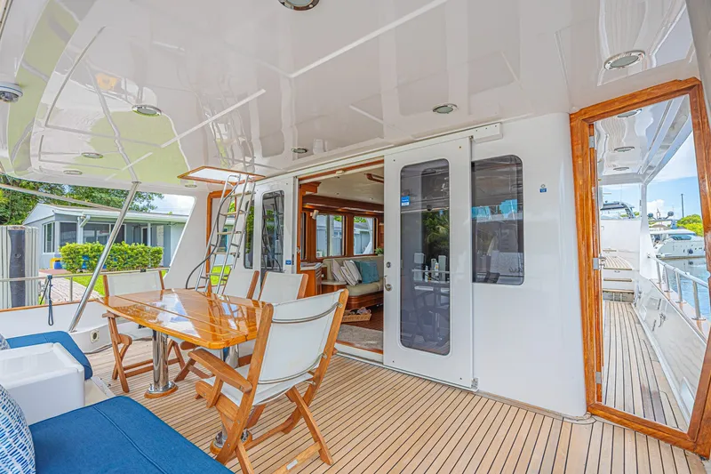 Slide: The Image of Luxurious 2005 Grand Banks 72 Aleutian RP yacht with elegant outdoor seating and dining area. - 13
