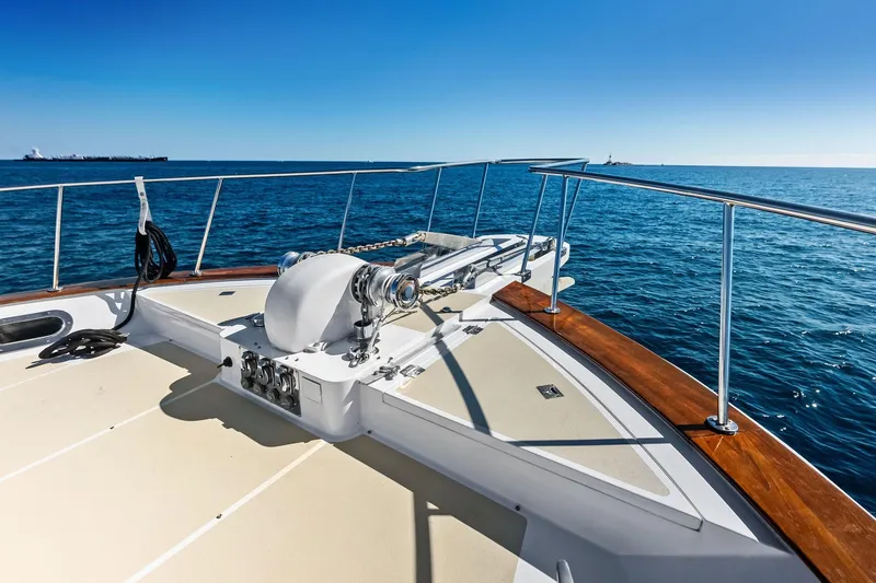 Slide: The Image of Bow of 2005 Grand Banks 72 Aleutian RP yacht on open sea under clear blue sky. - 171