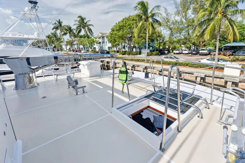 Slide: The Image of 2005 Grand Banks 72 Aleutian RP yacht deck with palm trees and marina view. - 130