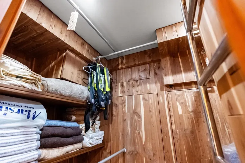 Slide: The Image of Wood-paneled storage room on 2005 Grand Banks 72 Aleutian RP yacht with shelves and hanging gear. - 104