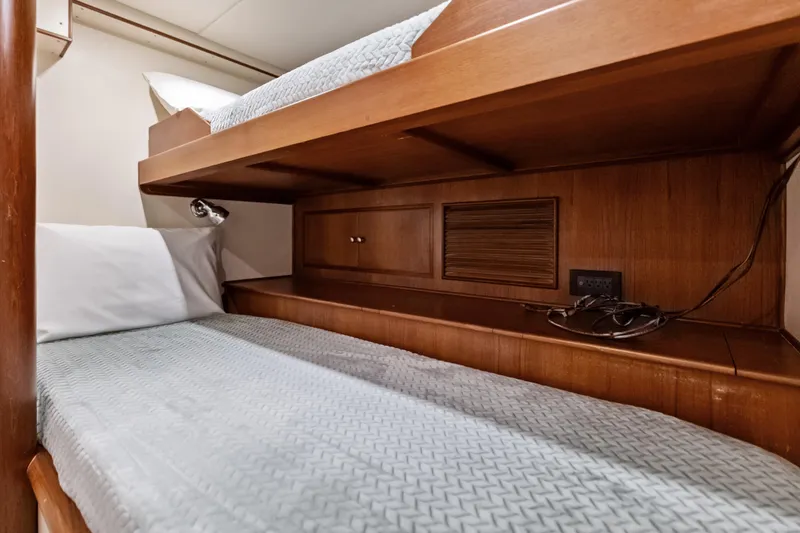 Slide: The Image of Bunk beds in 2005 Grand Banks 72 Aleutian RP yacht cabin, featuring wooden interior. - 153