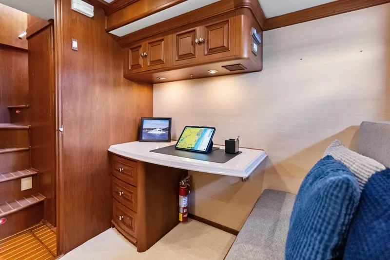 Slide: The Image of Luxurious 2005 Grand Banks 72 Aleutian RP yacht interior with wooden cabinetry and navigation setup. - 95