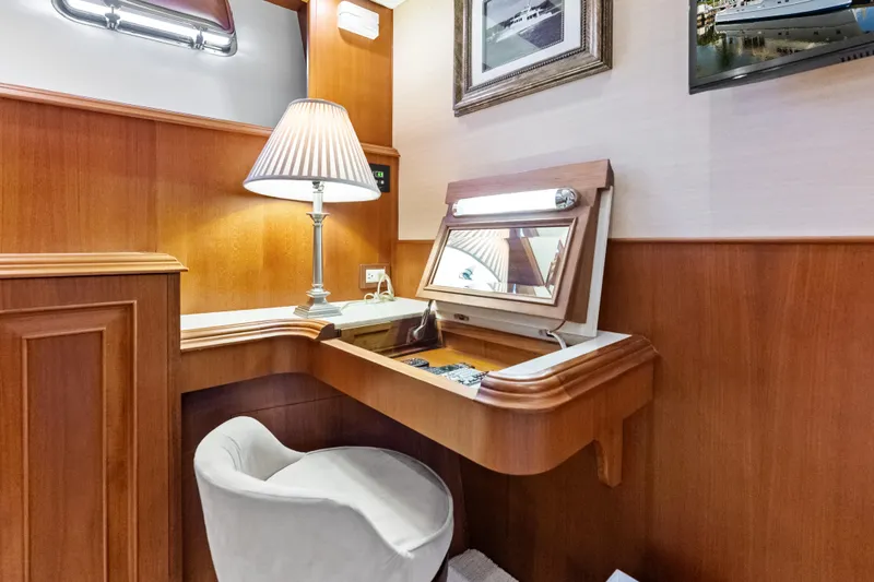 Slide: The Image of Elegant vanity area on 2005 Grand Banks 72 Aleutian RP yacht with lamp and mirror. - 101