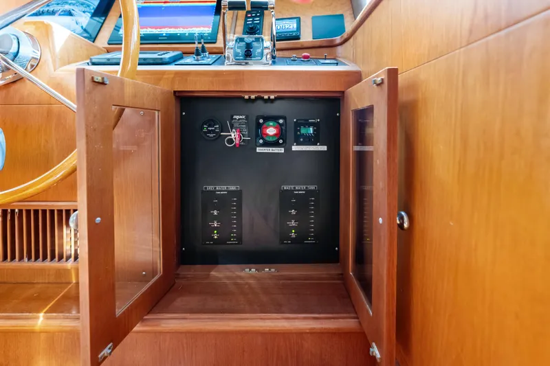 Slide: The Image of Control panel inside a 2005 Grand Banks 72 Aleutian RP yacht, featuring wooden cabinetry. - 87
