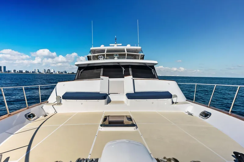 Slide: The Image of 2005 Grand Banks 72 Aleutian RP yacht cruising on open sea with city skyline. - 170