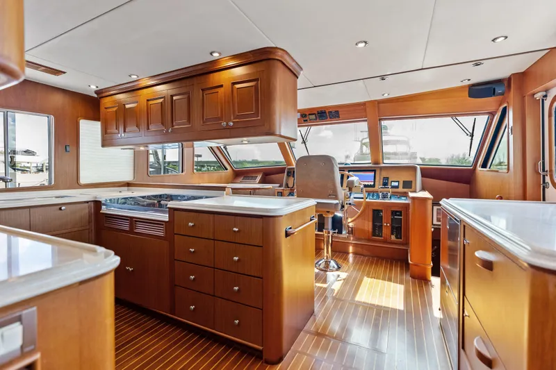 Slide: The Image of Luxurious interior of 2005 Grand Banks 72 Aleutian RP yacht with wooden cabinetry and helm station. - 72