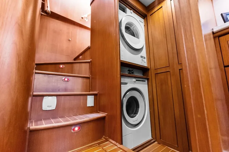 Slide: The Image of Laundry area on 2005 Grand Banks 72 Aleutian RP yacht with wooden stairs and cabinetry. - 92