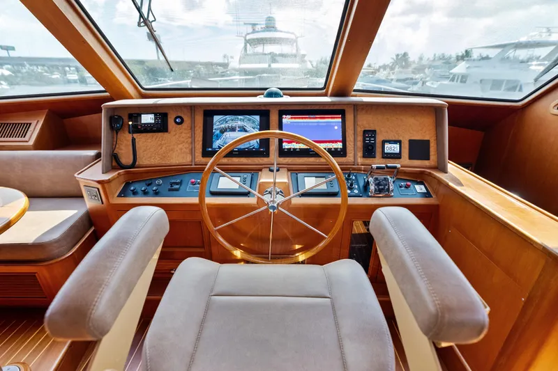 Slide: The Image of Helm of 2005 Grand Banks 72 Aleutian RP yacht with navigation equipment and wooden steering wheel. - 86