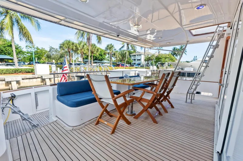Slide: The Image of Luxury deck of 2005 Grand Banks 72 Aleutian RP yacht with seating and ladder. - 52