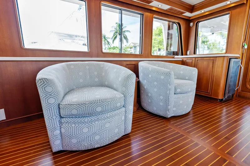 Slide: The Image of Luxurious interior of 2005 Grand Banks 72 Aleutian RP with patterned chairs and wooden flooring. - 68