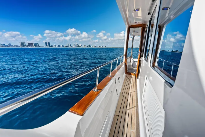 Slide: The Image of Side deck of 2005 Grand Banks 72 Aleutian RP yacht with ocean and city skyline view. - 169