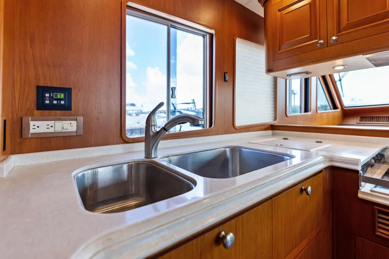 Slide: The Image of Luxurious kitchen interior of 2005 Grand Banks 72 Aleutian RP yacht with dual sinks. - 79