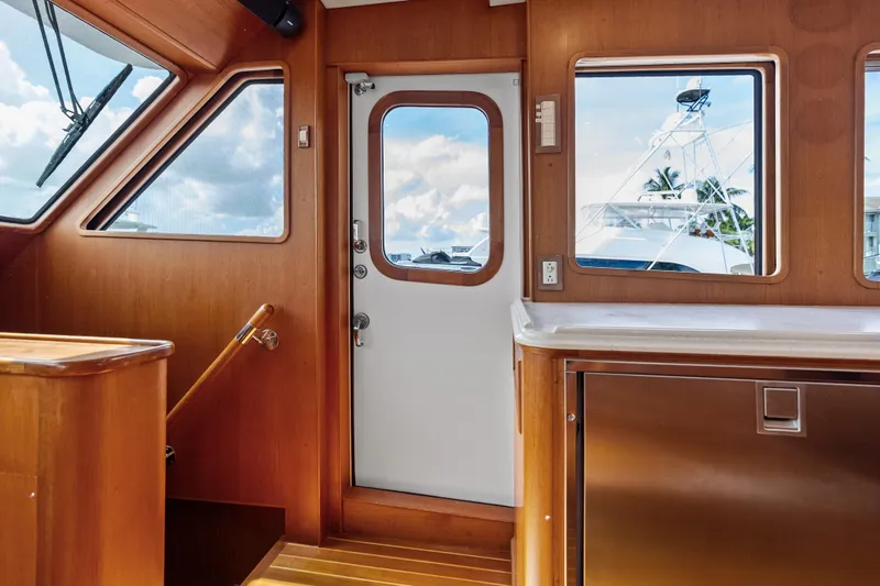 Slide: The Image of Interior of 2005 Grand Banks 72 Aleutian RP yacht with wooden finishes and windows. - 91