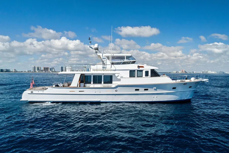 Slide: The Image of 2005 Grand Banks 72 Aleutian RP yacht cruising on open sea under blue sky. - 31