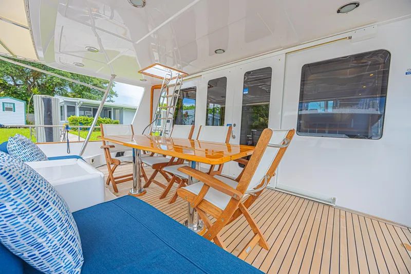 Slide: The Image of Spacious deck of 2005 Grand Banks 72 Aleutian RP yacht with elegant seating and table. - 25
