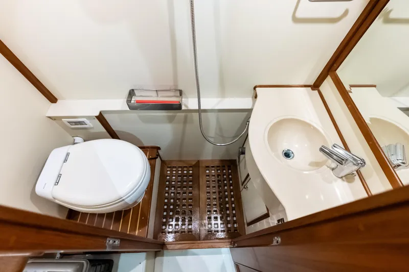 Slide: The Image of Luxurious bathroom in 2005 Grand Banks 72 Aleutian RP yacht, featuring modern fixtures and wooden accents. - 154