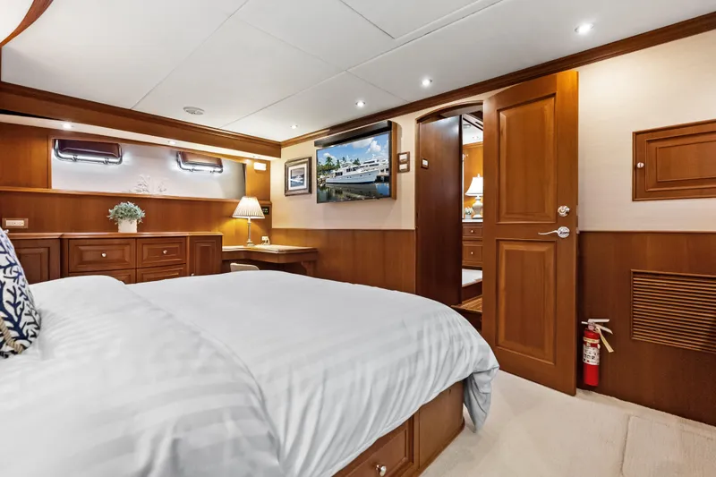 Slide: The Image of Luxurious cabin interior of 2005 Grand Banks 72 Aleutian RP yacht, featuring elegant wood finishes. - 98
