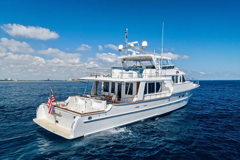 Slide: The Image of 2005 Grand Banks 72 Aleutian RP yacht cruising on open sea under blue sky. - 183