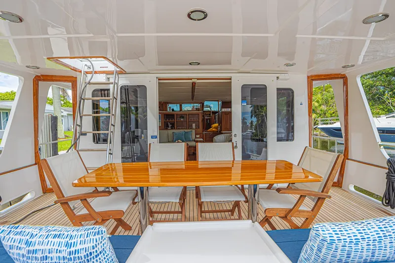 Slide: The Image of Luxurious 2005 Grand Banks 72 Aleutian RP yacht deck with elegant dining area and seating. - 14