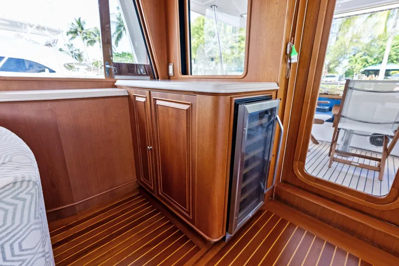 Slide: The Image of Luxurious interior of 2005 Grand Banks 72 Aleutian RP yacht with wooden cabinetry and wine cooler. - 63
