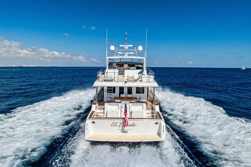 Slide: The Image of 2005 Grand Banks 72 Aleutian RP yacht cruising on open sea under clear blue sky. - 38