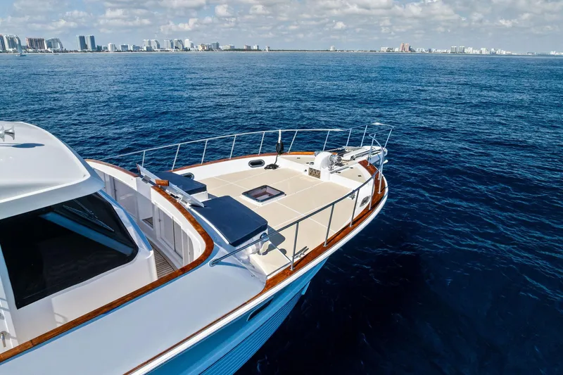 Slide: The Image of 2005 Grand Banks 72 Aleutian RP yacht cruising near city skyline on a sunny day. - 196