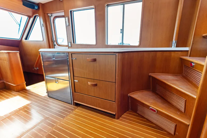 Slide: The Image of Interior of 2005 Grand Banks 72 Aleutian RP yacht with wooden cabinetry and stairs. - 81