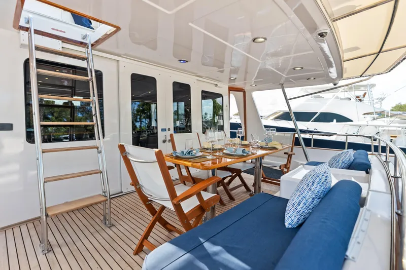 Slide: The Image of Luxury outdoor dining area on 2005 Grand Banks 72 Aleutian RP yacht with elegant seating. - 56