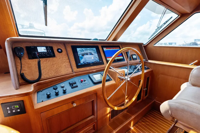 Slide: The Image of Helm of 2005 Grand Banks 72 Aleutian RP yacht with navigation equipment and wooden steering wheel. - 83