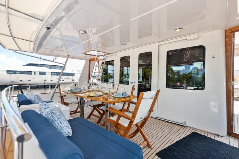 Slide: The Image of Luxurious 2005 Grand Banks 72 Aleutian RP yacht deck with elegant dining setup. - 58