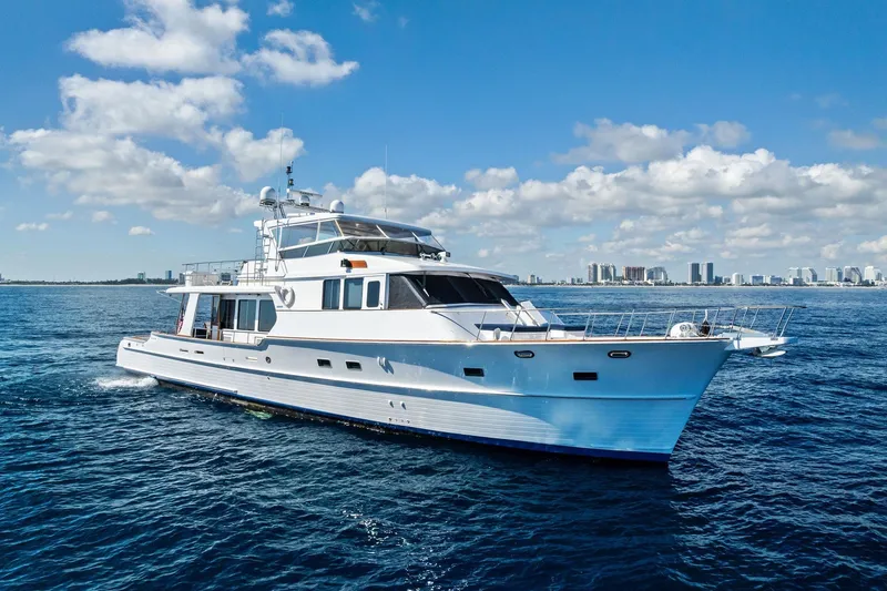 Slide: The Image of 2005 Grand Banks 72 Aleutian RP yacht cruising on open water under a clear sky. - 182
