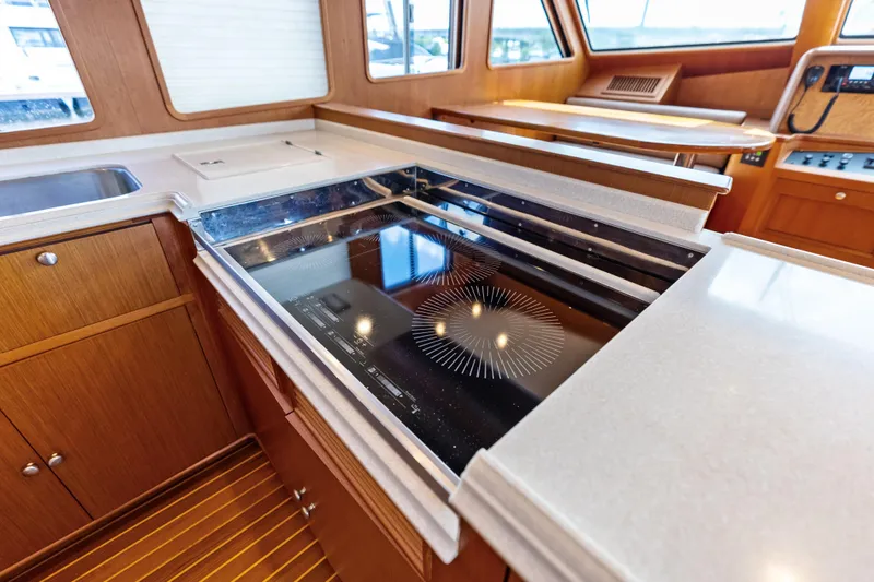 Slide: The Image of Luxurious kitchen area in a 2005 Grand Banks 72 Aleutian RP yacht with modern appliances. - 75