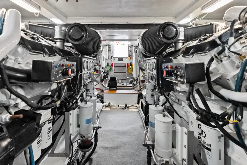 Slide: The Image of Engine room of 2005 Grand Banks 72 Aleutian RP yacht, showcasing dual engines and control systems. - 142