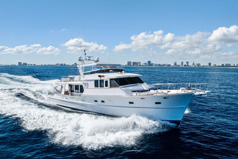 Slide: The Image of 2005 Grand Banks 72 Aleutian RP yacht cruising on open sea under clear skies. - 179