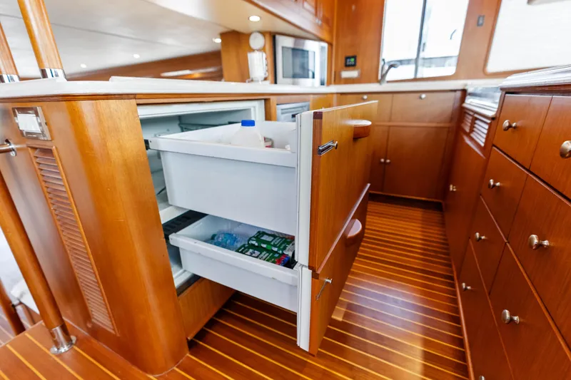 Slide: The Image of Luxury yacht kitchen with open refrigerator drawers, Grand Banks 72 Aleutian RP, 2005 model. - 78