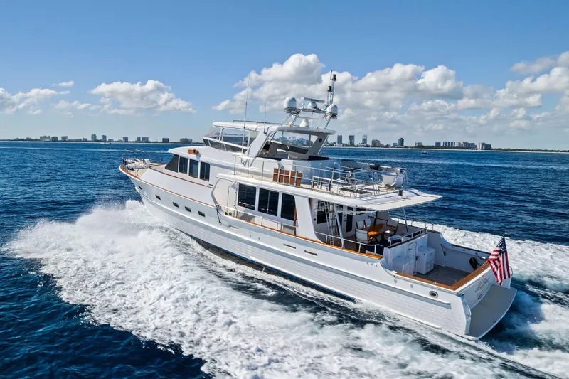 Slide: The Image of 2005 Grand Banks 72 Aleutian RP yacht cruising on open water under clear skies. - 199