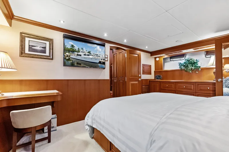 Slide: The Image of Luxurious cabin interior of 2005 Grand Banks 72 Aleutian RP yacht, featuring elegant wood finishes. - 99
