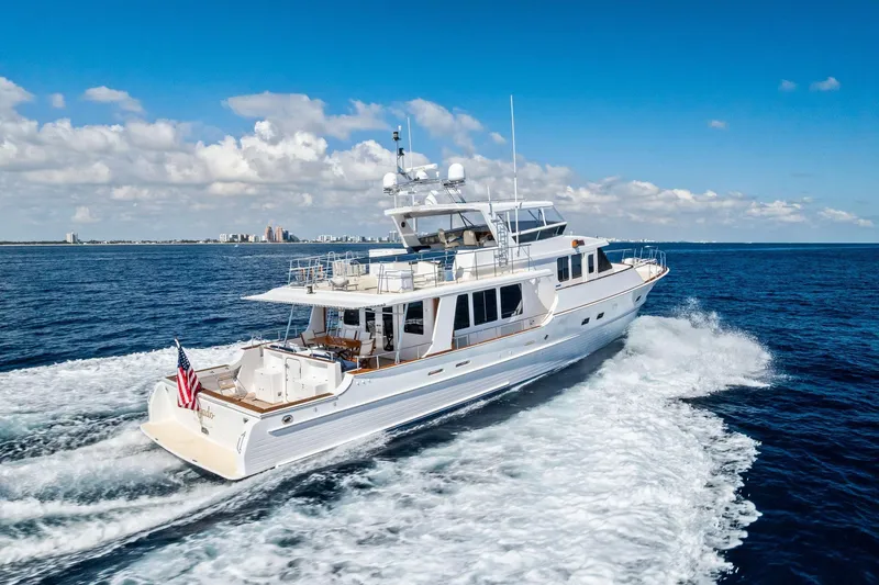 Slide: The Image of 2005 Grand Banks 72 Aleutian RP yacht cruising on open sea under blue sky. - 191