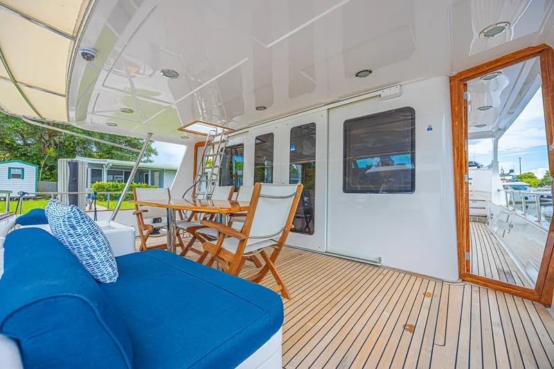 Slide: The Image of Luxurious 2005 Grand Banks 72 Aleutian RP yacht deck with seating and dining area. - 26