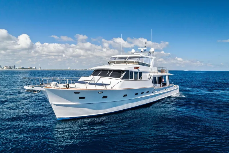 Slide: The Image of 2005 Grand Banks 72 Aleutian RP yacht cruising on open sea under clear blue sky. - 192