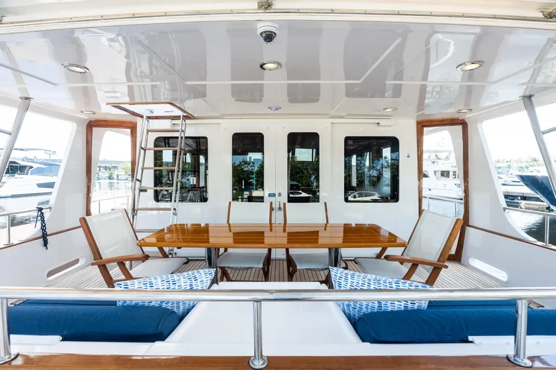 Slide: The Image of Luxurious 2005 Grand Banks 72 Aleutian RP yacht deck with elegant seating and dining area. - 50