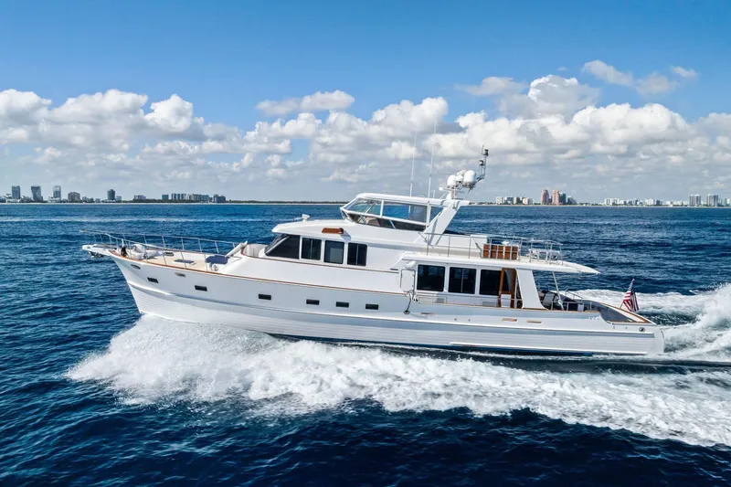 Slide: The Image of 2005 Grand Banks 72 Aleutian RP yacht cruising on open water under a clear sky. - 181