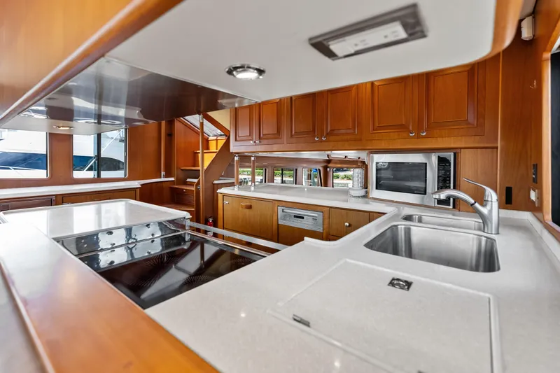Slide: The Image of Luxurious kitchen interior of 2005 Grand Banks 72 Aleutian RP yacht, featuring modern appliances. - 73