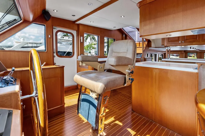 Slide: The Image of Luxurious interior of 2005 Grand Banks 72 Aleutian RP yacht with wooden helm and seating. - 88